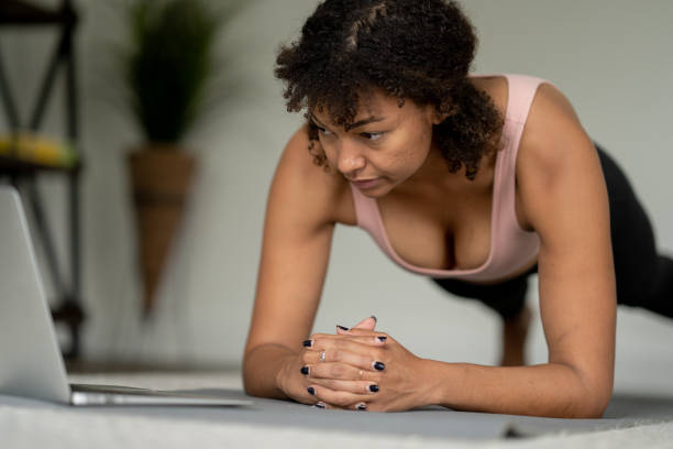 istock Woman Planking at Home with a Virtual Class 1392345437