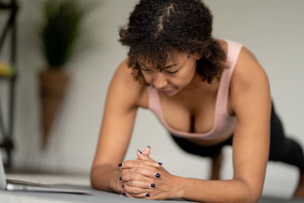 istock Woman Planking at Home with a Virtual Class 1392345448