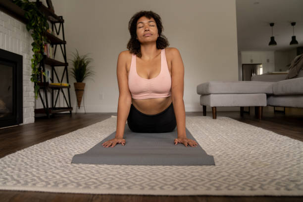 istock Woman Stretching at Home 1392345450