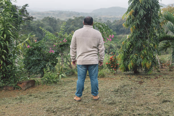 Young man with wide open arms in the landscape