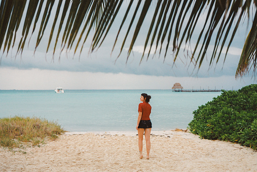 Young Caucasian woman  walking on the  of seaside on Cozumel Island