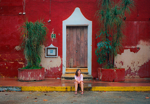 Young Caucasian woman  sitting near the doors  in San Cristobal de las Casas