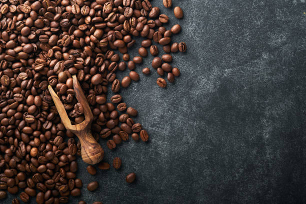 istock Coffee beans background. Roasted Coffee beans on dark black stone background. Top view. Coffee concept. Mock up. 1392349267