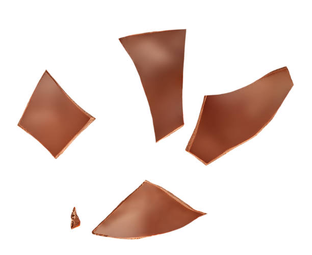 istock Crushed Chocolate pieces isolated on white background. Milk chocolate closeup