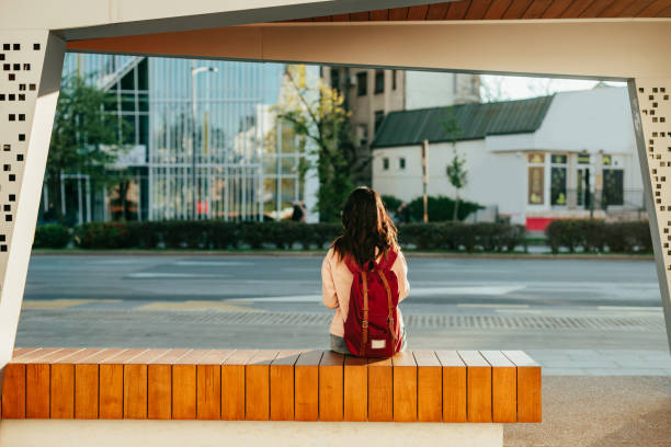 Woman sitting on bus station