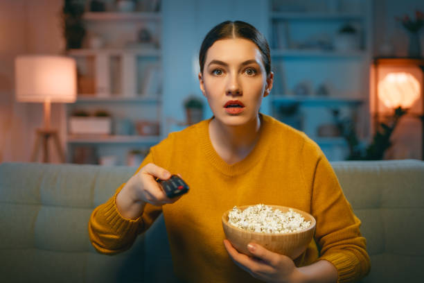 istock woman watching TV 1392352643
