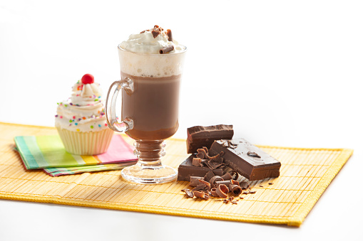 Chocolate milkshake composition with cupcake and chocolate bar.