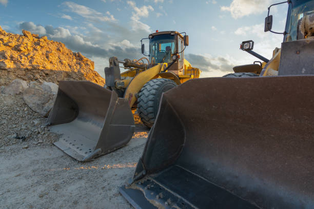istock Excavator moving dirt and sand at a construction site 1392356435