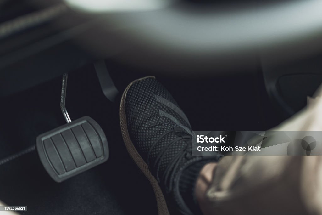 Foot on the accelerator for a right hand drive Gas Pedal Stock Photo