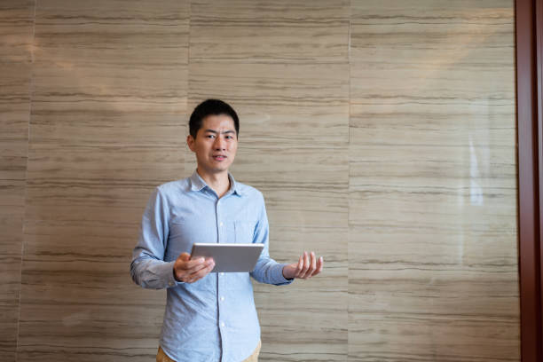 istock business man holding tablet 1392356567