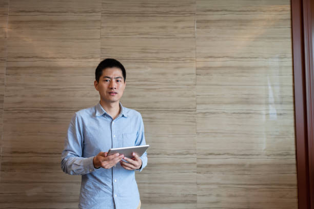istock business man holding tablet 1392356585