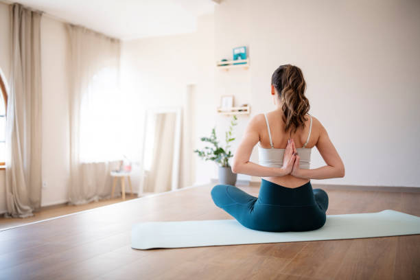 istock Woman in lotus position meditating. 1392359082