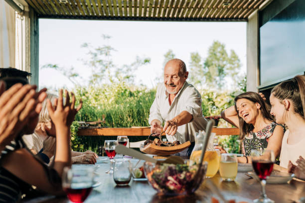 istock Multi-generational family gathered for weekend dinner in patio 1392359288
