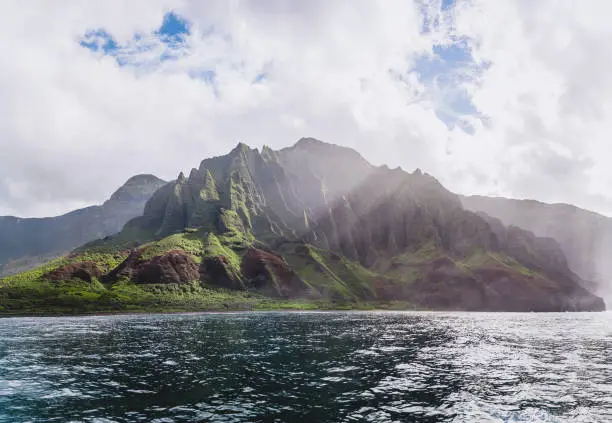 Napali Coast in Kauai, Hawaii from a boat. With beautiful blue sky