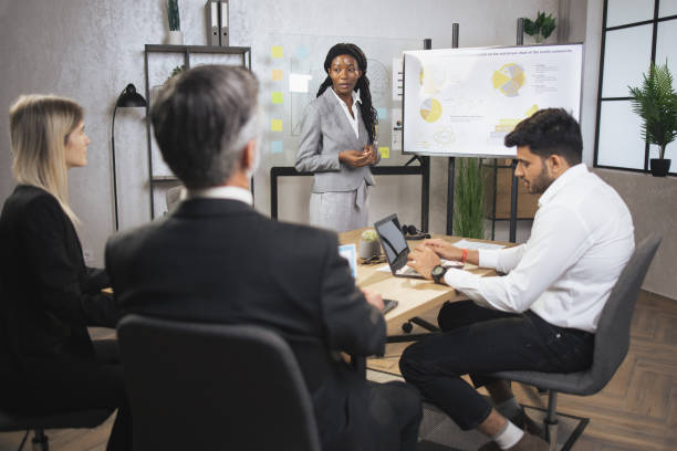 istock Business team of four good-looking experienced multiethnic corporate workers 1392359646