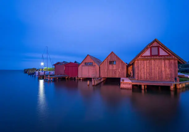 Water views and boathouses in Ahrenshoop harbour in the evening