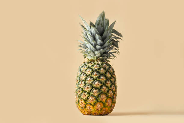 istock Whole pineapple isolated on the beige background 1392361191