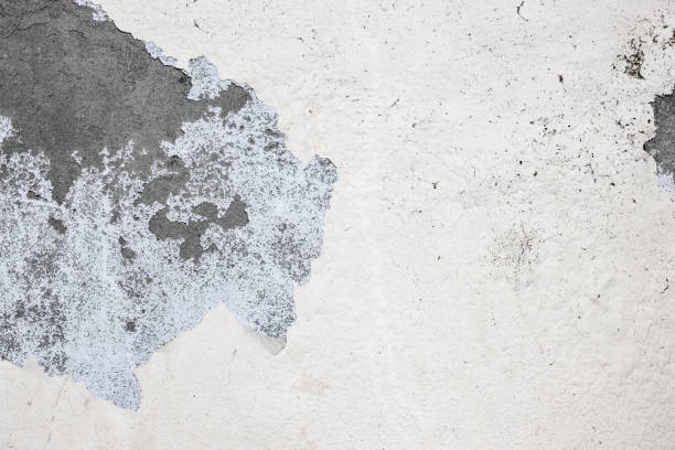 istock Damaged old concrete plaster wall surface close up 1392361246