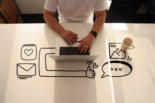 istock A man is traying to create digital content on her laptop with line icons 1392361438