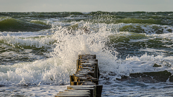 Groynes in the surf of the Baltic Sea on the Darß
