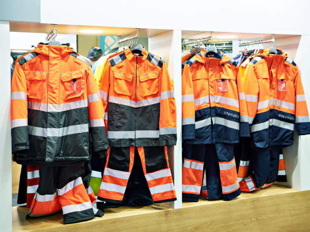 istock Suits clothes for workers in red fluorescent color in store 1392362431