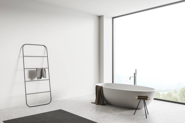 istock Corner view on bright bathroom interior with bathtub, panoramic window 1392364175
