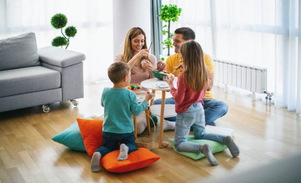 istock Family painting Easter eggs together. 1392364937