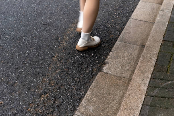 istock woman walking by the road 1392365262