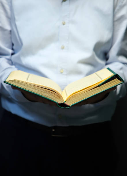istock man holding holy quran and reading quran 1392367410