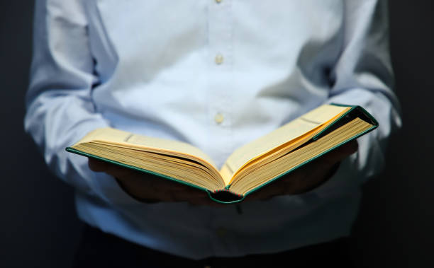 istock man holding holy quran and reading quran 1392367471