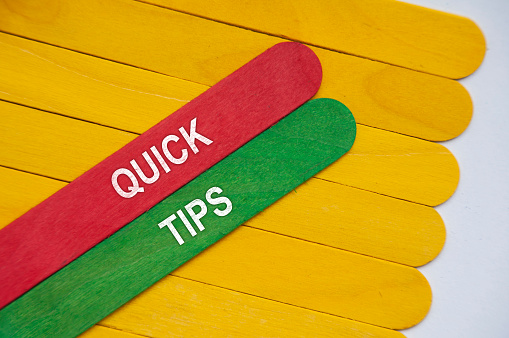 Quick tips text on red and green wooden stick.