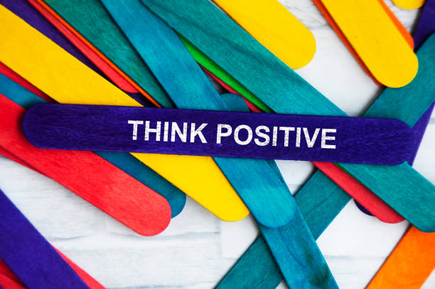 istock Think positive text on blue wooden stick. 1392367586