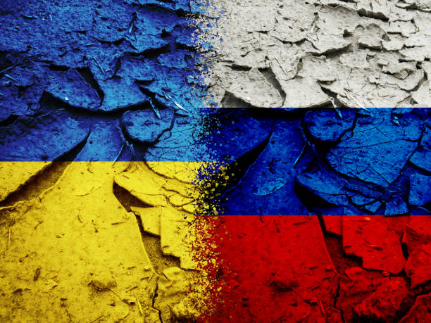 istock Russia vs Ukraine national flags on dry cracking earth 1392374127