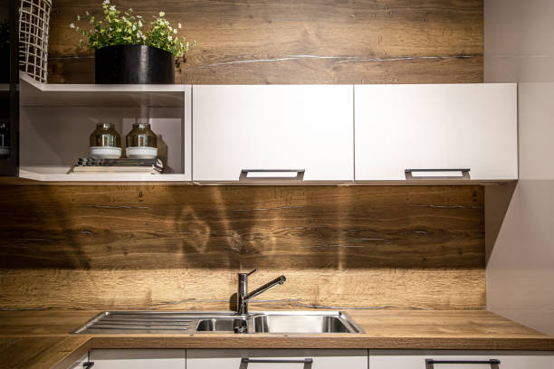 istock Modern wooden kitchen interior, steel kitchen faucet. 1392374198