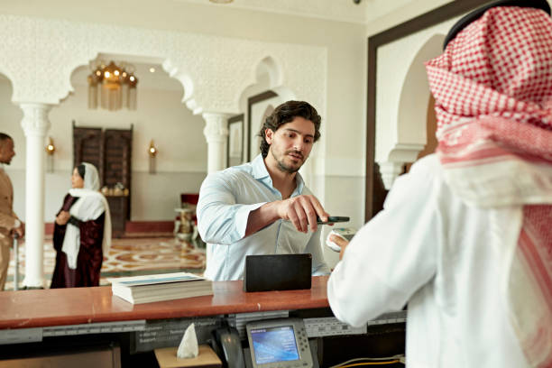 istock Saudi hotel guest making contactless payment at check-out 1392375170