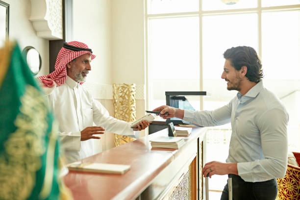 istock Guest making contactless payment when checking out of hotel 1392375176