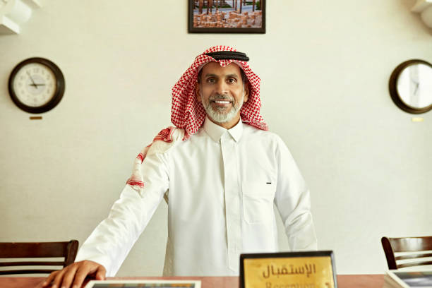 istock Luxury hotel receptionist in traditional Saudi attire 1392375839