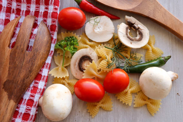 Farfalle or bowtie pasta with tomatoes, mushrooms, chillies, dill and parsley