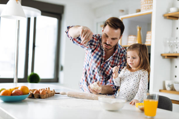 istock Father and daughter baking cookies 1392377092