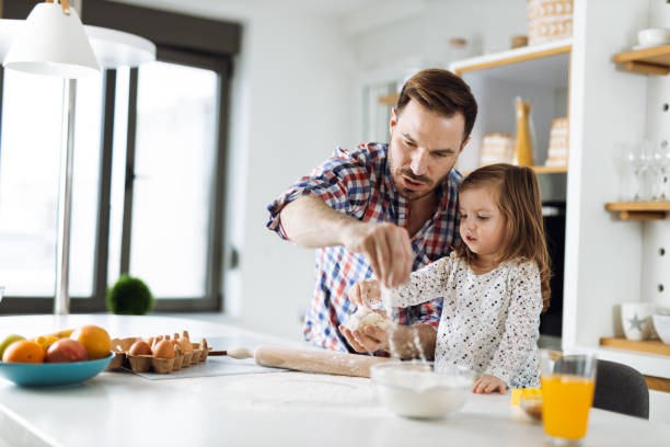 istock Father and daughter baking cookies 1392377605