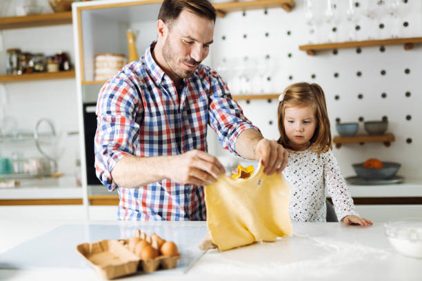 istock Father and daughter baking cookies 1392377884