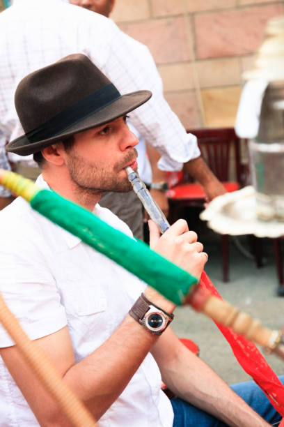 istock Man Smoking a Hookah Pipe at a Shisha Bar in Luxor, Egypt 1392379774