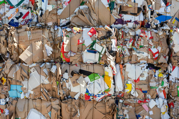 Close up of stacked waste paper in front of a recycling facility stock photo