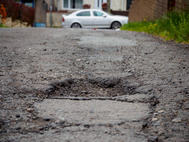 istock Pothole in British road, major problem for car damage, accidents and insurance claims 1392382057