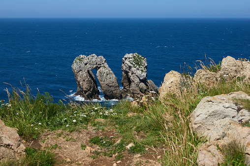 A beautiful view of whimsical rock formations on cliffs in northern Spain.