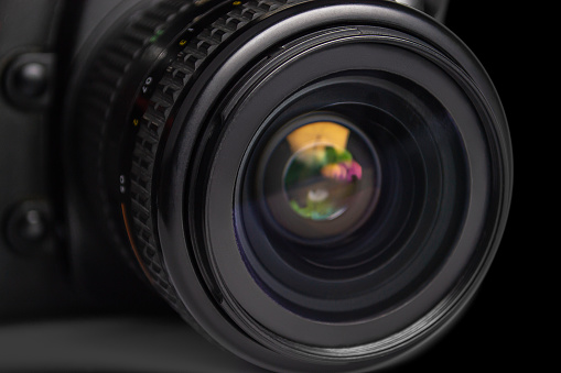 close up of camera photo lens on black background