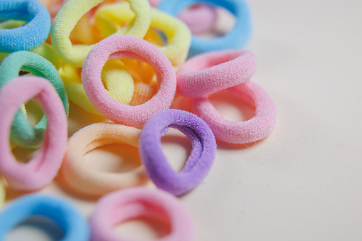 close up of rotating multi colored rubber bands. defocused macro shot abstract rotating circular textile hair elastic, selective focus