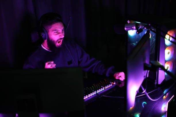 istock young man playing computer games at home neon beam studio man wearing headphones having fun playing games on the internet 1392385734