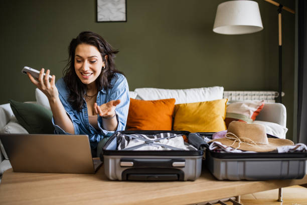 istock Young woman talking on a video call and getting ready for vacation 1392387559