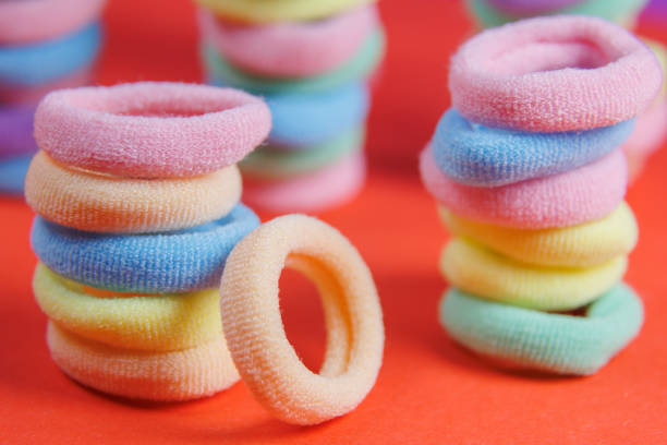 istock rubber bands close up very colorful rotating colors red background, 1392387738
